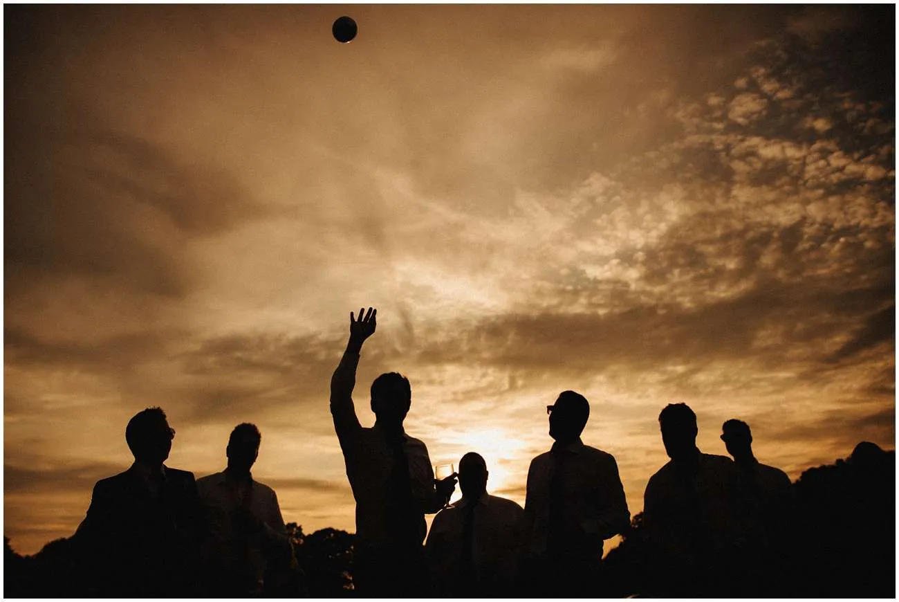 A silhouette of the guests playing games during sunset