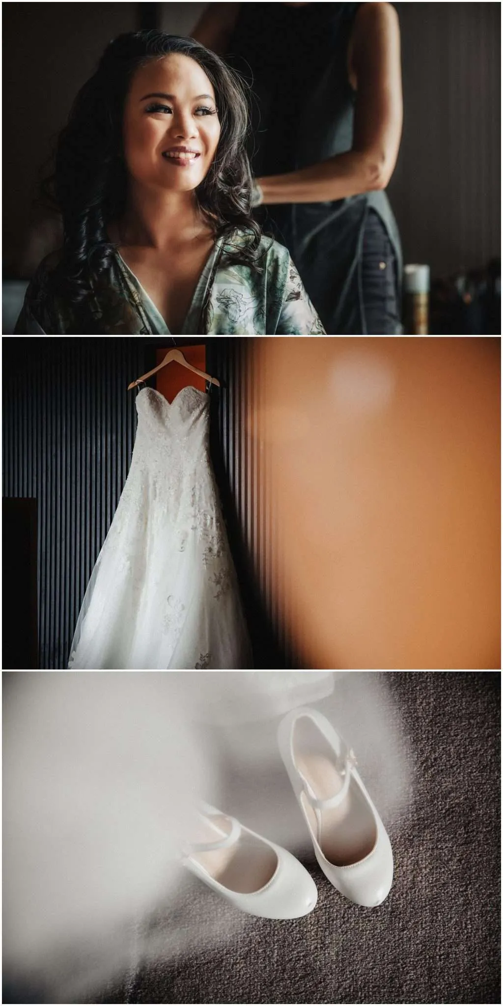 A happy bride gets her hair done with her wedding dress hanging on the wall and shoes below