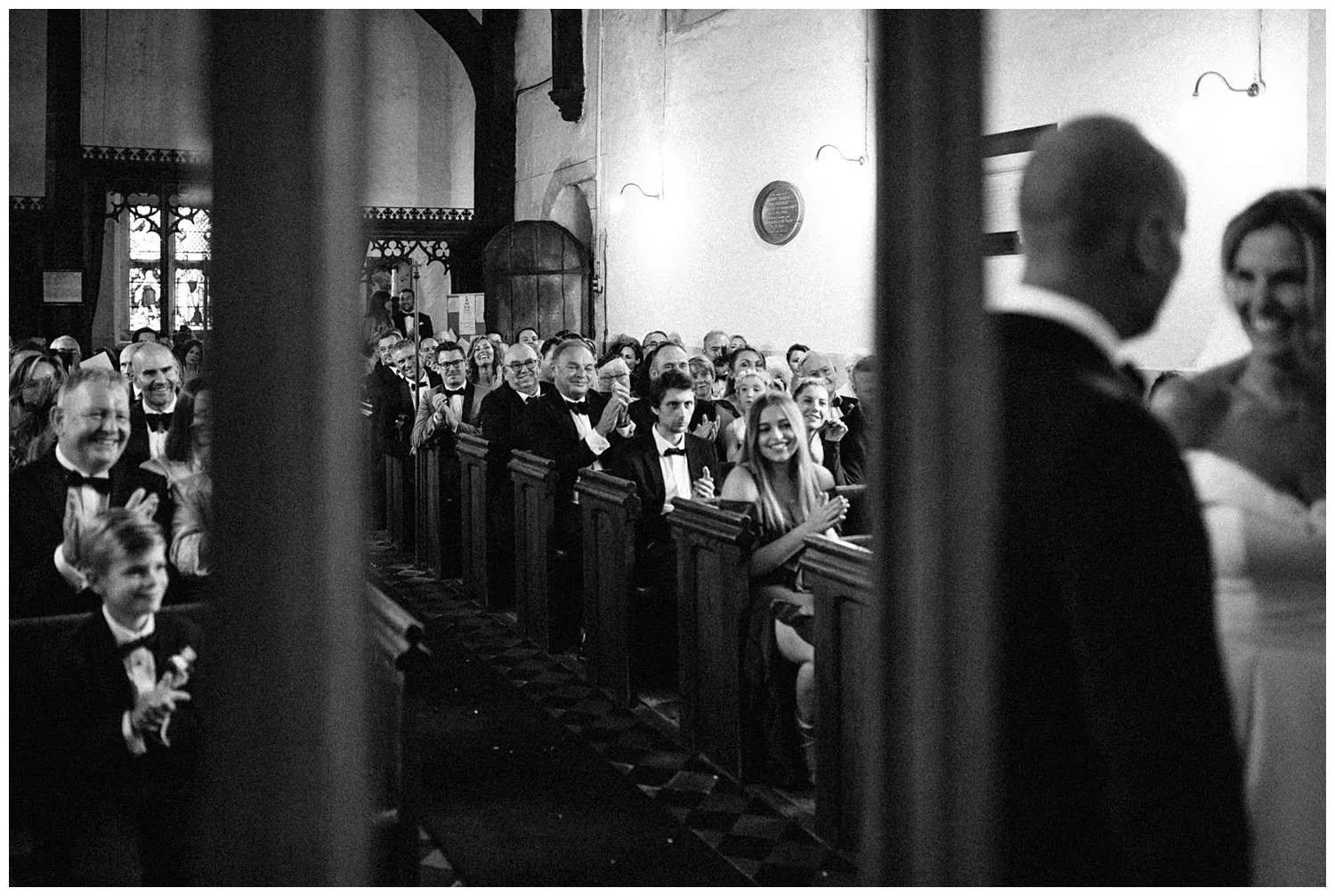 Black and white image of guests clapping