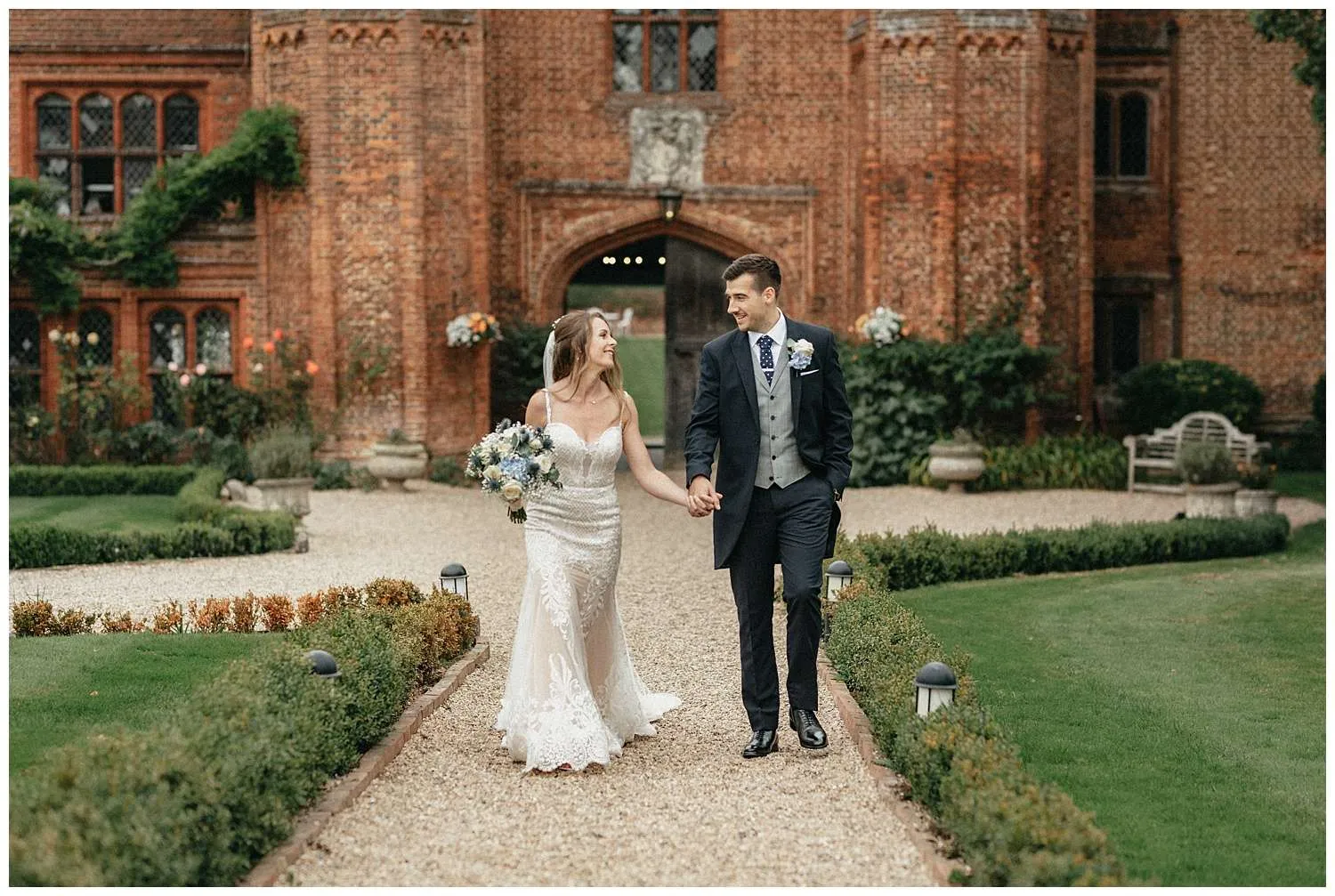 Portrait of the bride and groom walking holding hands