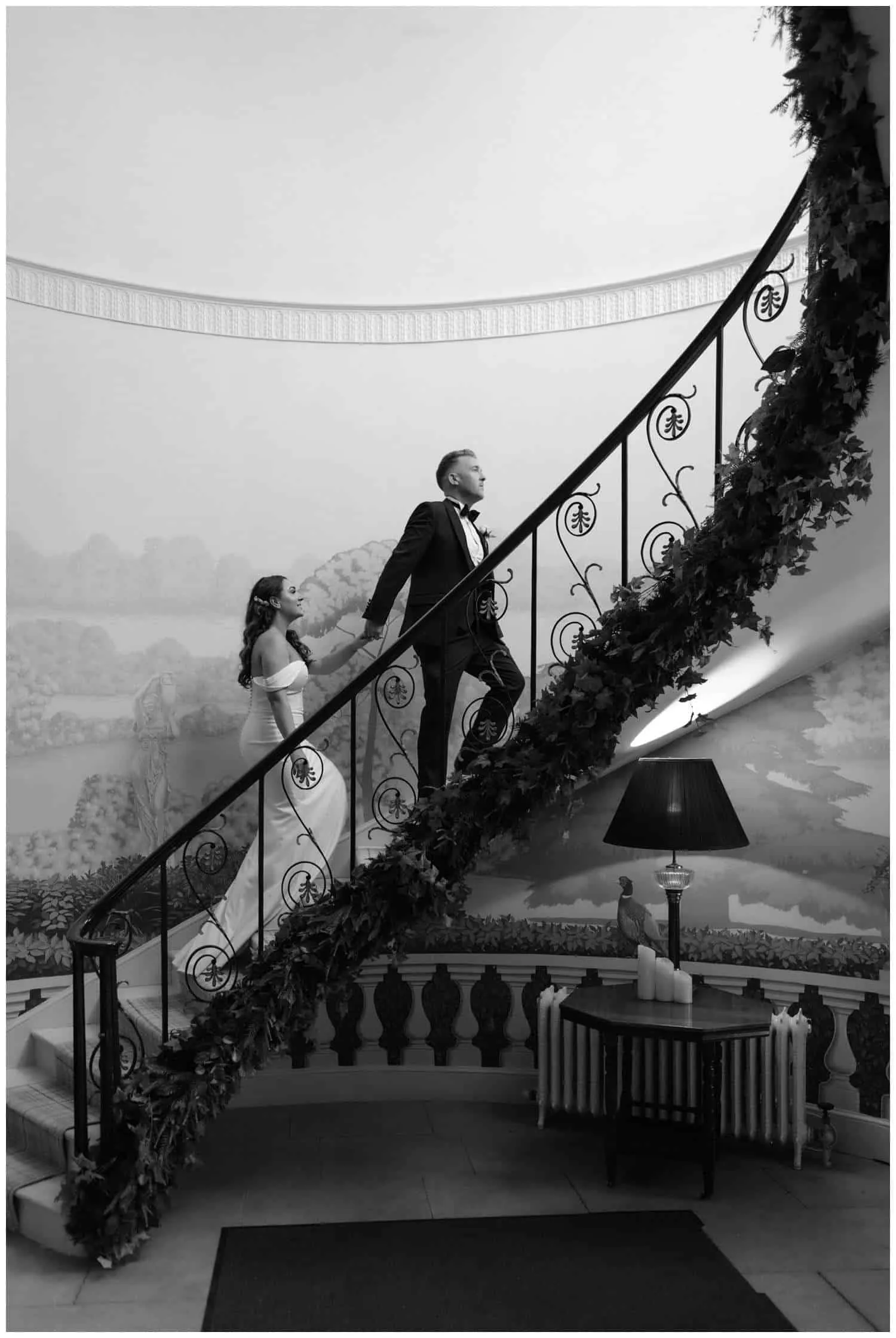Weddings at Hatfield Place - The bride and groom walk up the winding staircase in the main building
