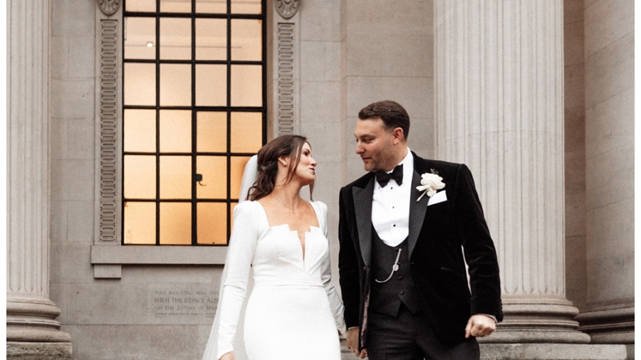 Marylebone Town Hall Wedding photographer - The bride and groom walk down the stairs outside the venue