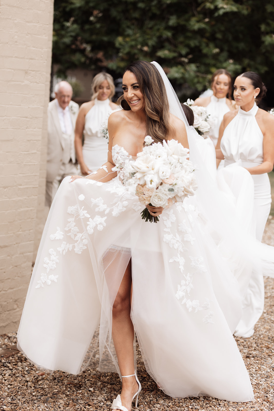 Candid, real moment for the bride and bridesmaids as they walk in the grounds of That Amazing Place