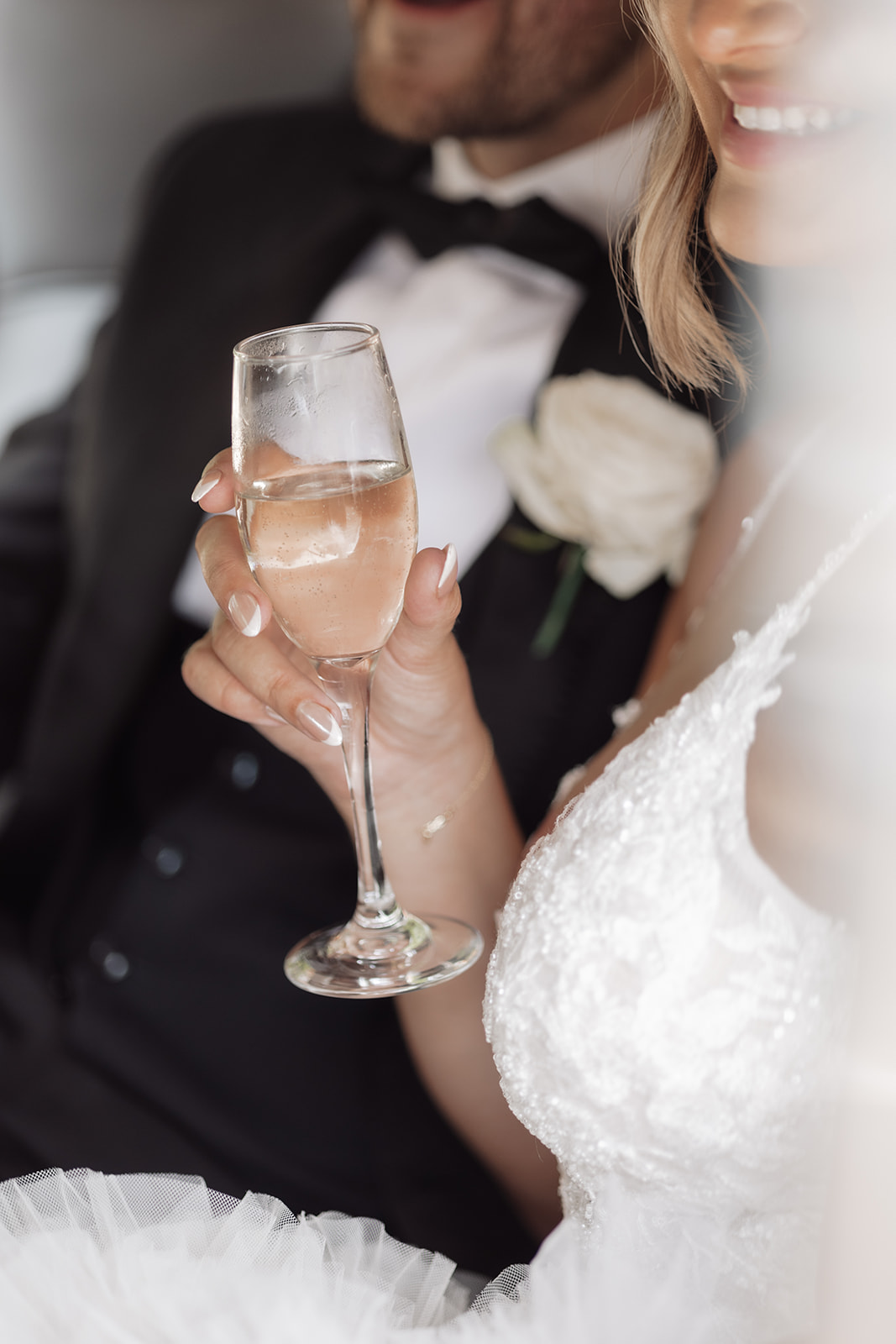 Authentic, intimate moment between the bride and groom as they sip champagne at Hedingham Castle