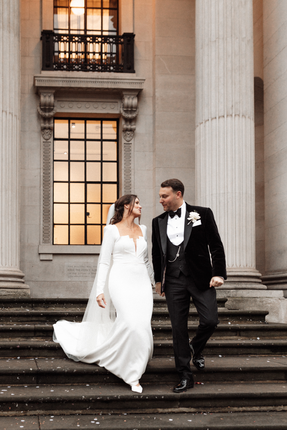 unposed and unfiltered London Wedding photography of a couple walking down the stairs at the Marylebone Town Hall