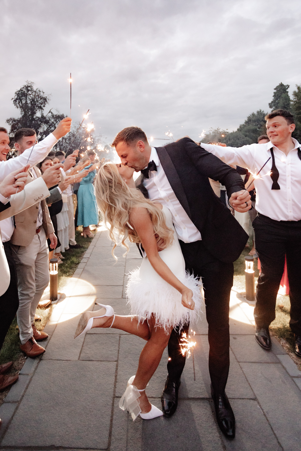 An unplanned, genuine moment for the bride and groom as they kiss during the sparklers at Swynford Manor