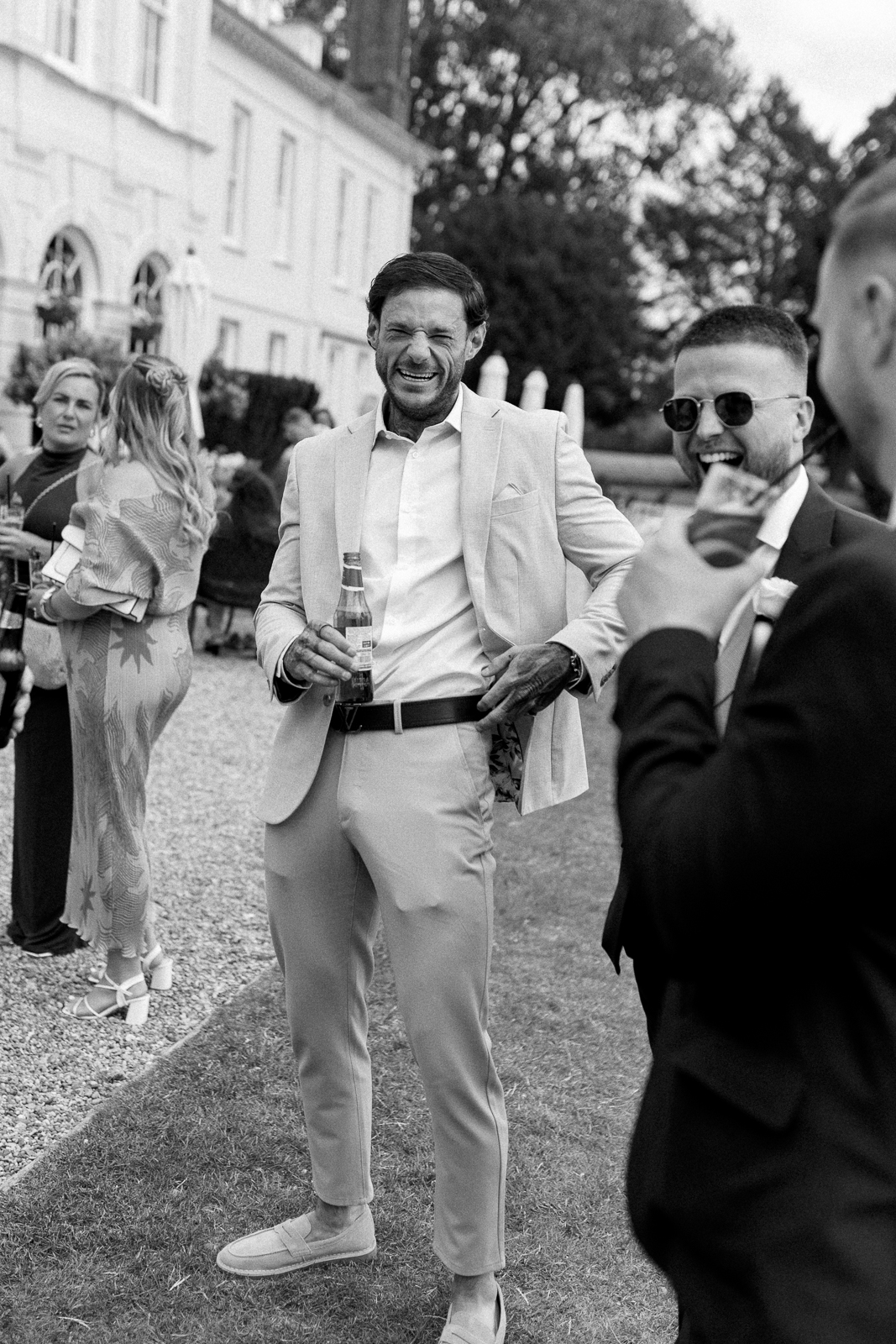 Summer drinks reception at Gosfield Hall with guests enjoying the Bubbles and Beer cart