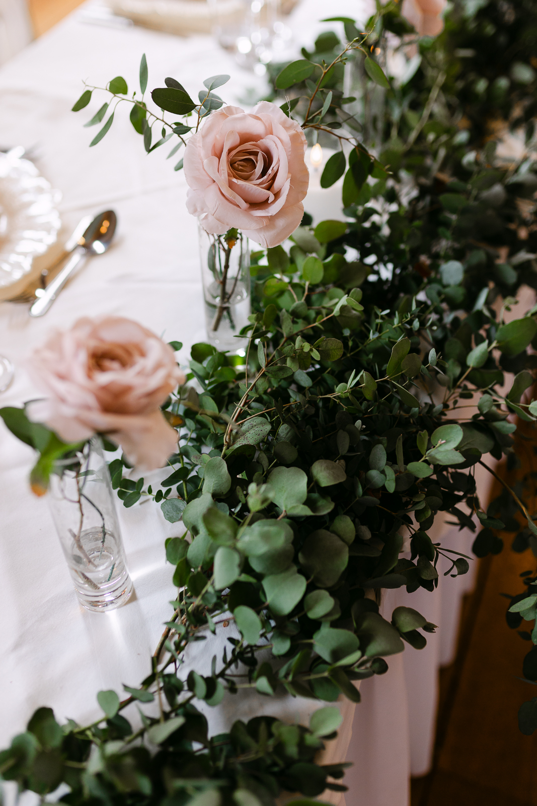 Blush pink rose and eucalyptus wedding table flowers at Gosfield Hall