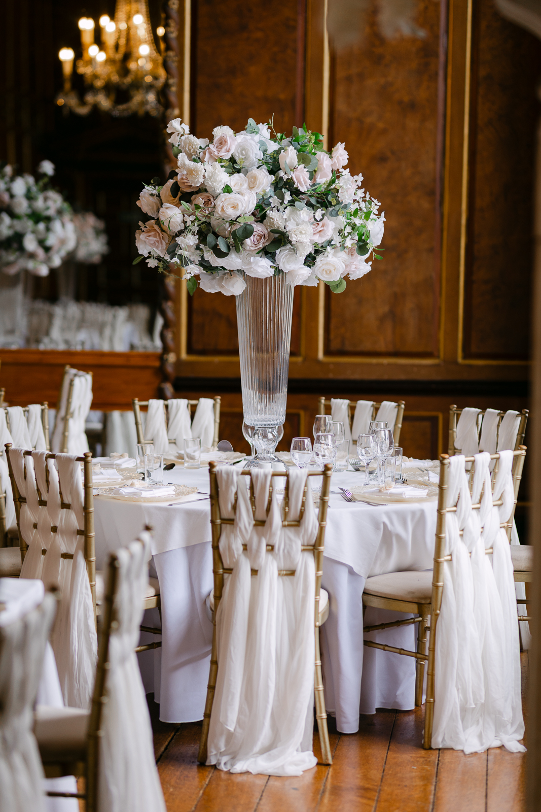 Elegant wedding breakfast tables decorated with flowers inside Gosfield Hall