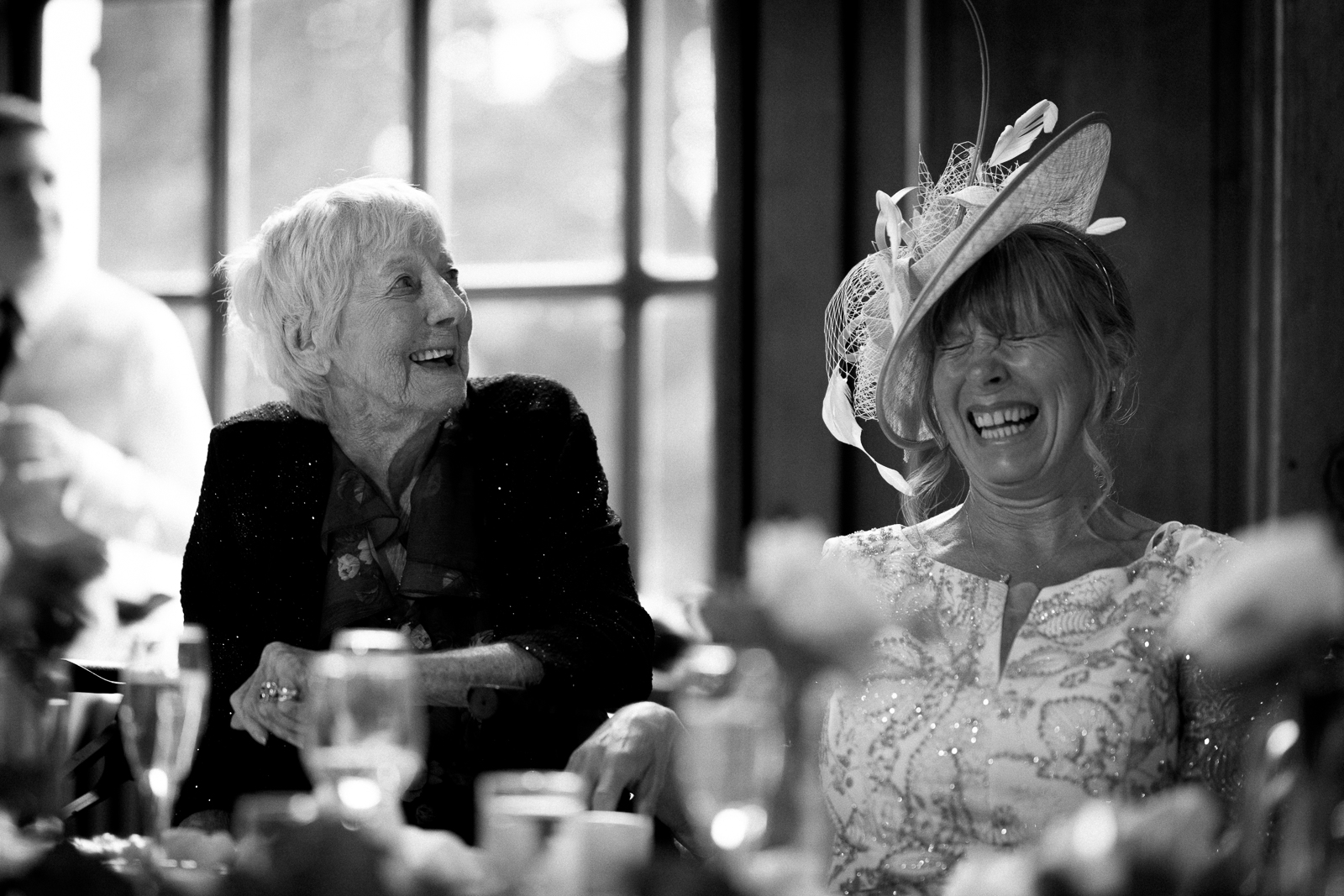 Family members laughing together during Molly and Taylor's wedding speeches