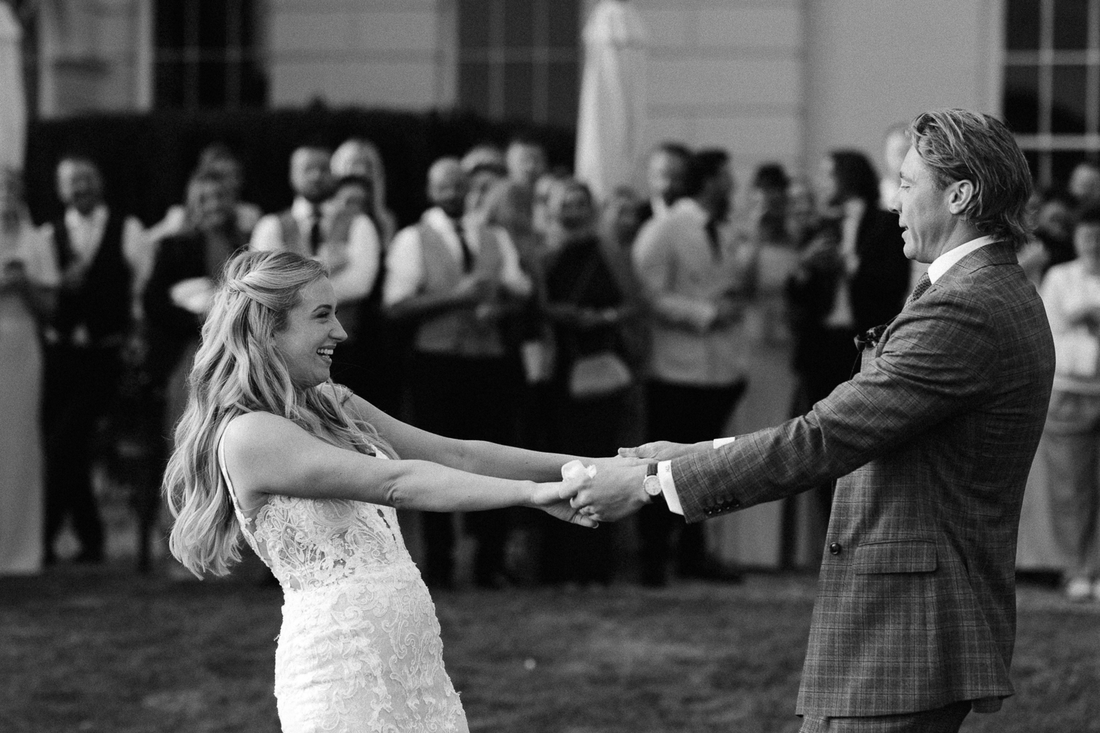 Black and white photograph of Molly and Taylor's outdoor first dance at Gosfield Hall
