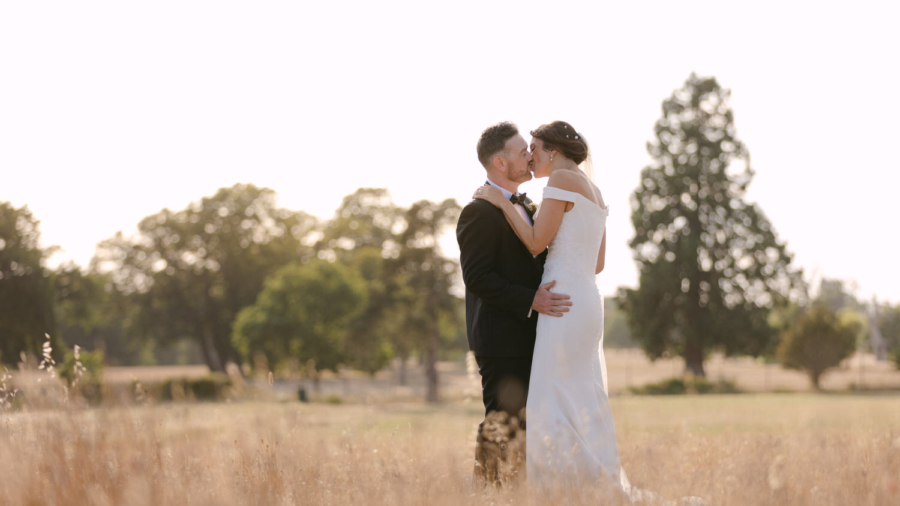 Relaxed sunset portrait of Chris and Sarah embracing outdoors